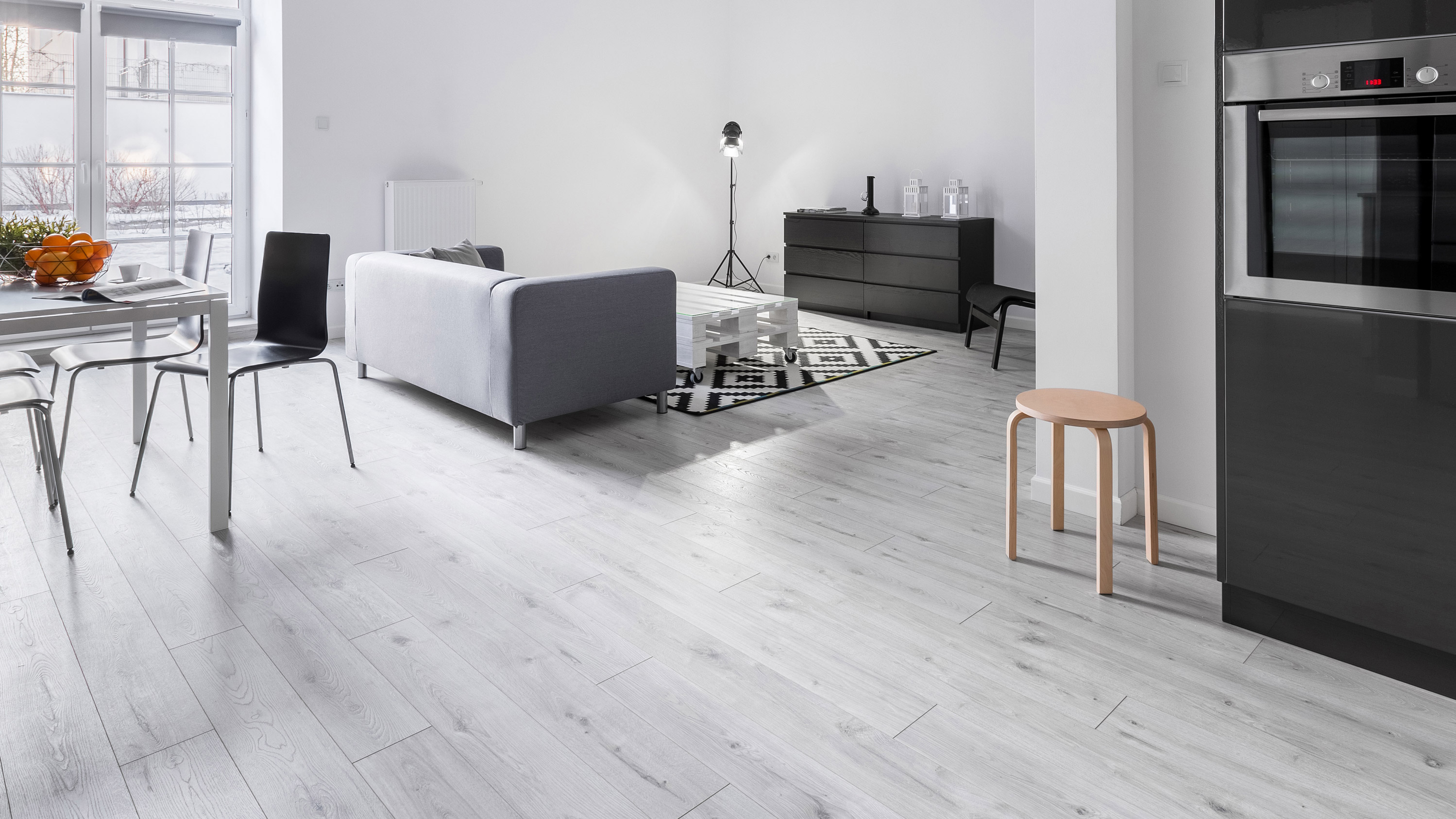 Kitchen of the wooden house with an indoor garden in the background